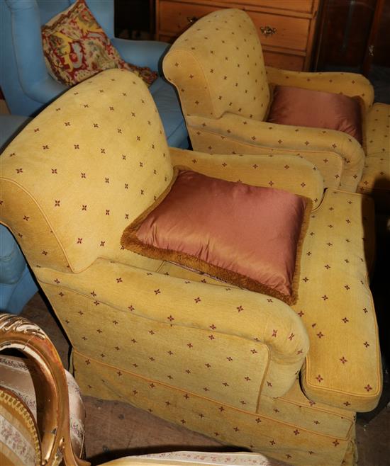 A pair of gold fabric upholstered armchairs